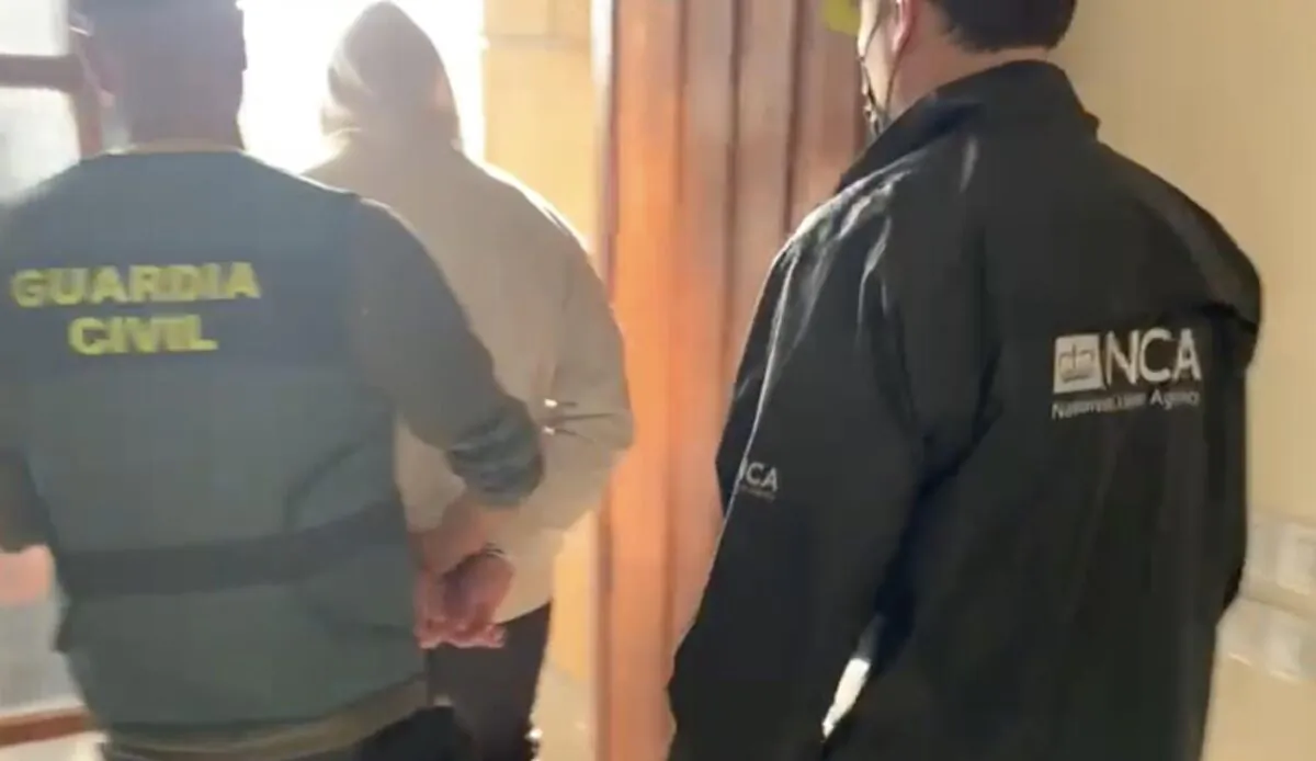A man is arrested by the Guardia Civil and the National Crime Agency in Madrid, Spain, on Oct. 4, 2022. (National Crime Agency)