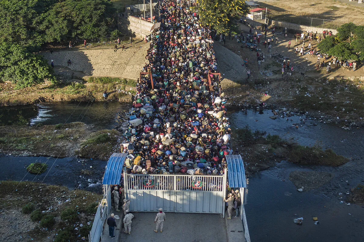 Haitians wait to cross the border from Haiti into the Dominican Republic in Dajabon, Dominican Republic, on Nov. 19, 2021. (Matias Delacroix/AP Photo)