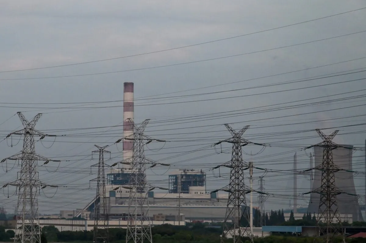 High voltage relay towers are seen in front of the Wujing coal-electricity power station in the Minhang district of Shanghai on Aug. 22, 2022. (Hector Retamal/AFP via Getty Images)