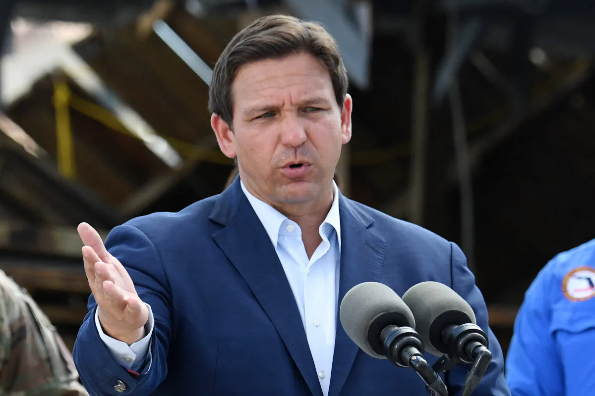 Florida Gov. Ron DeSantis speaks in a neighborhood impacted by Hurricane Ian at Fisherman's Wharf in Fort Myers, Fla., on Oct. 5, 2022. (Olivier Douliery/AFP via Getty Images)