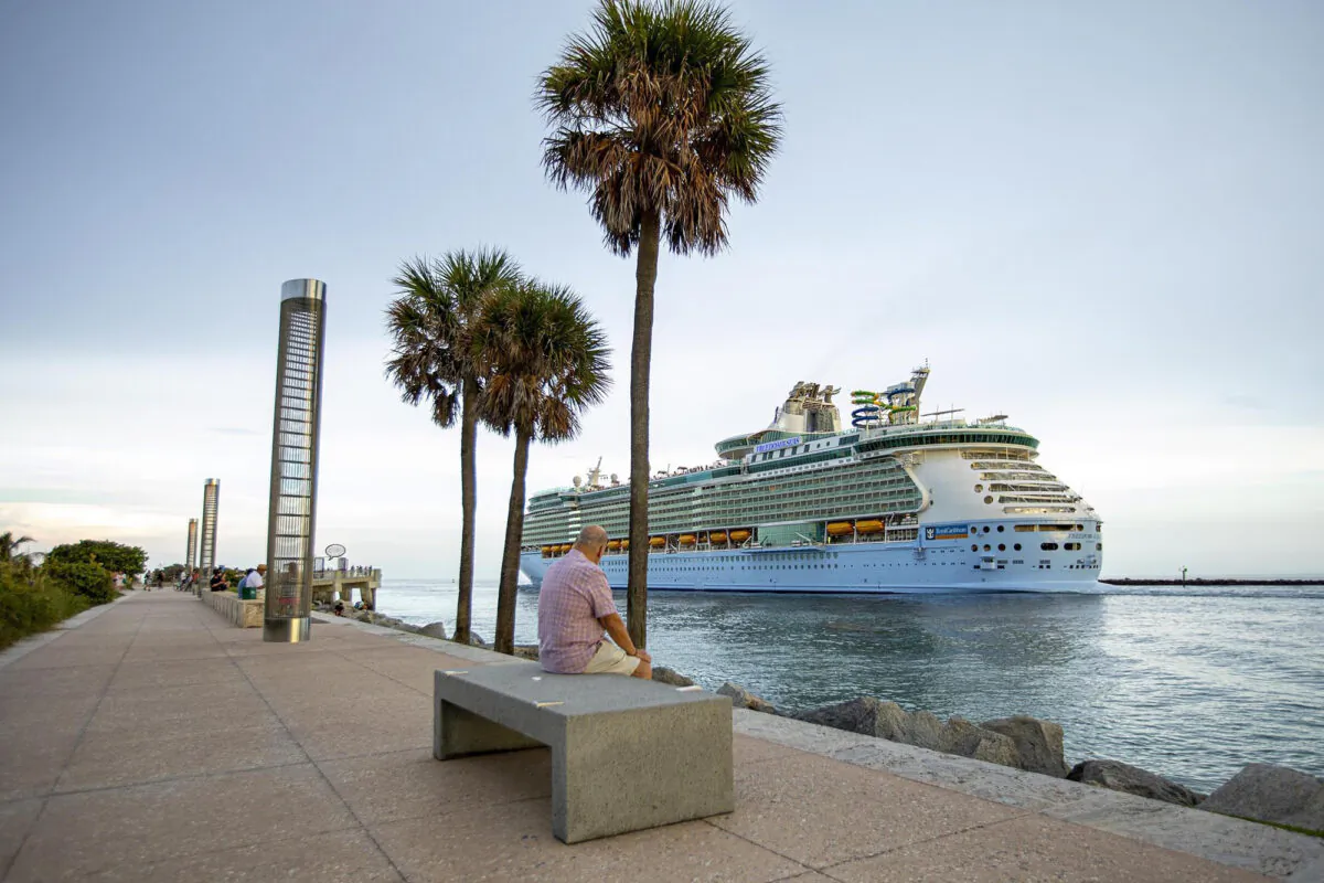 A man watches as Royal Caribbean International's Freedom of the Seas cruise ship sets off down Government Cut past Miami's South Pointe Park on a simulated voyage from PortMiami on June 20, 2021. (Daniel A. Varela/Miami Herald/TNS)