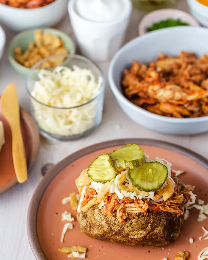 Whether cobbled together from leftovers in the fridge for a weeknight dinner, or served as an over-the-top spread for a party, a baked potato bar is always a crowd-pleaser. (Meleyna Nomura/TNS)