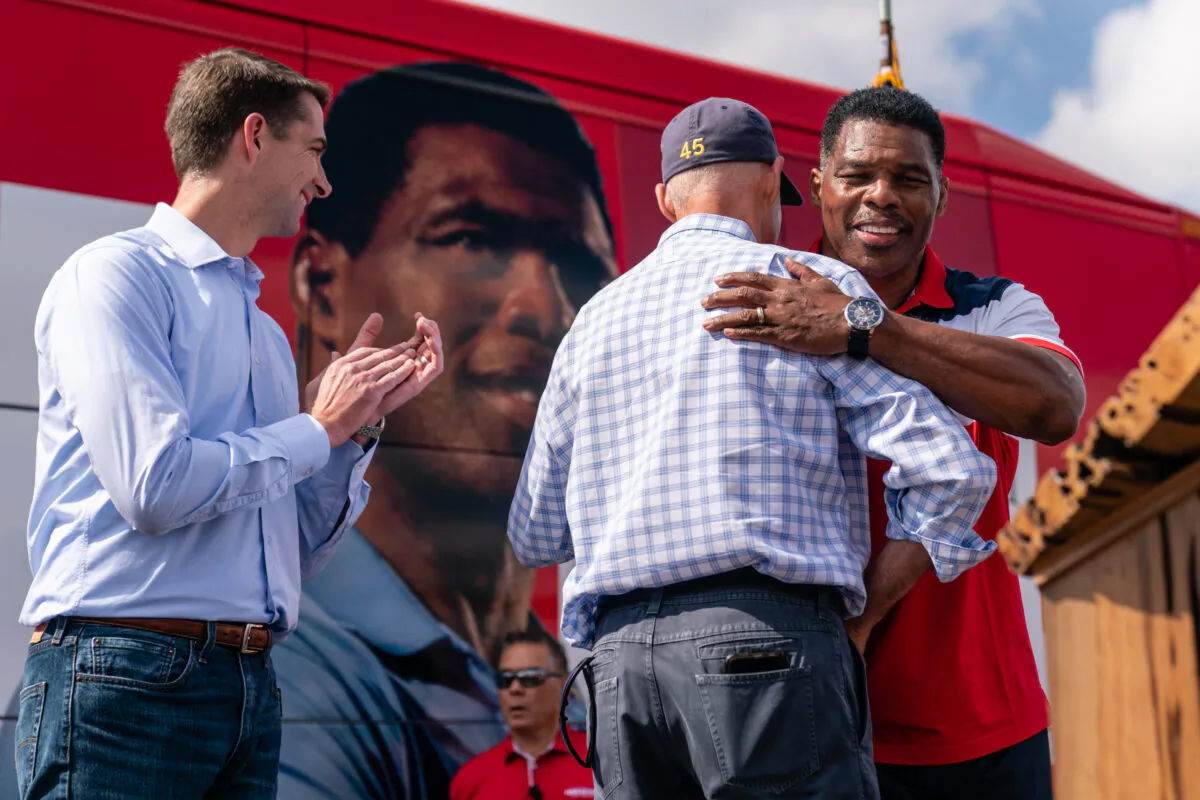 Georgia Republican Senatorial candidate Herschel Walker embraces Sen. Rick Scott (R-Fla.) before speaking at a campaign event in Carrollton, Ga., on Oct. 11, 2022. (Elijah Nouvelage/Getty Images)