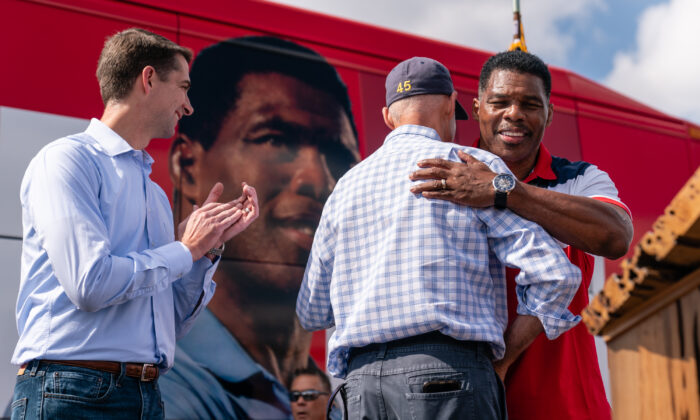 Georgia Republican Senatorial candidate Herschel Walker embraces Sen. Rick Scott (R-Fla.) before speaking at a campaign event in Carrollton, Ga., on Oct. 11, 2022. (Elijah Nouvelage/Getty Images)