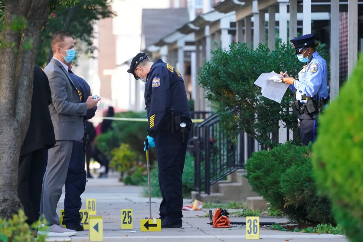 Investigators work the scene where multiple people were shot including police officers in Philadelphia on Oct. 12, 2022. (Matt Rourke/AP Photo)