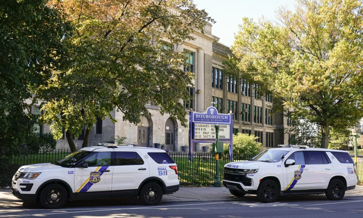 Police vehicles are parked at Roxborough High School, near where multiple people were shot the previous day, in Philadelphia on Sept. 28, 2022. (Matt Rourke/AP Photo)
