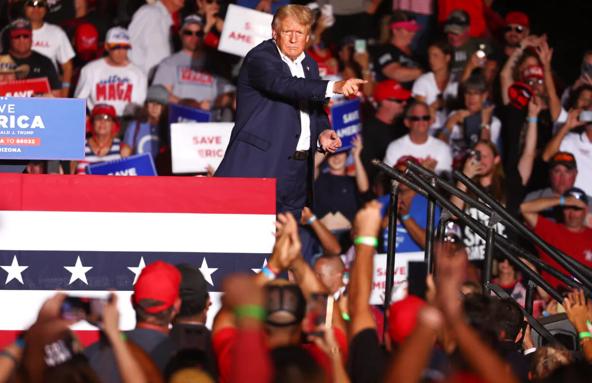 Former President Donald Trump gestures to the crowd at a campaign rally at Legacy Sports USA in Mesa, Ariz., on Oct. 9, 2022. (Mario Tama/Getty Images)
