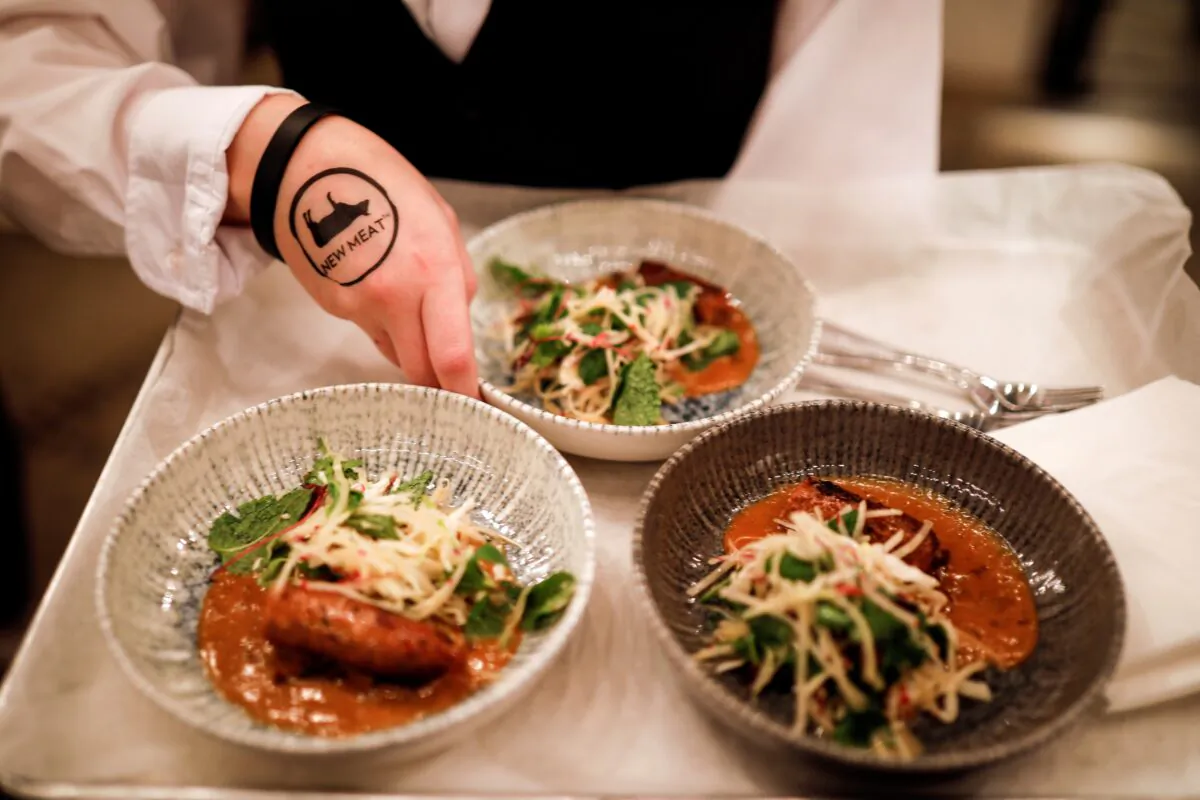 A chef prepares dishes with 3D printed plant-based meat products, mimicking beef, produced by Israeli start-up Redefine Meat as part of an event marking the international commercial launch of its New-Meat product range in a restaurant in Tel Aviv, Israel, on Nov. 15, 2021. (Amir Cohen/Reuters)