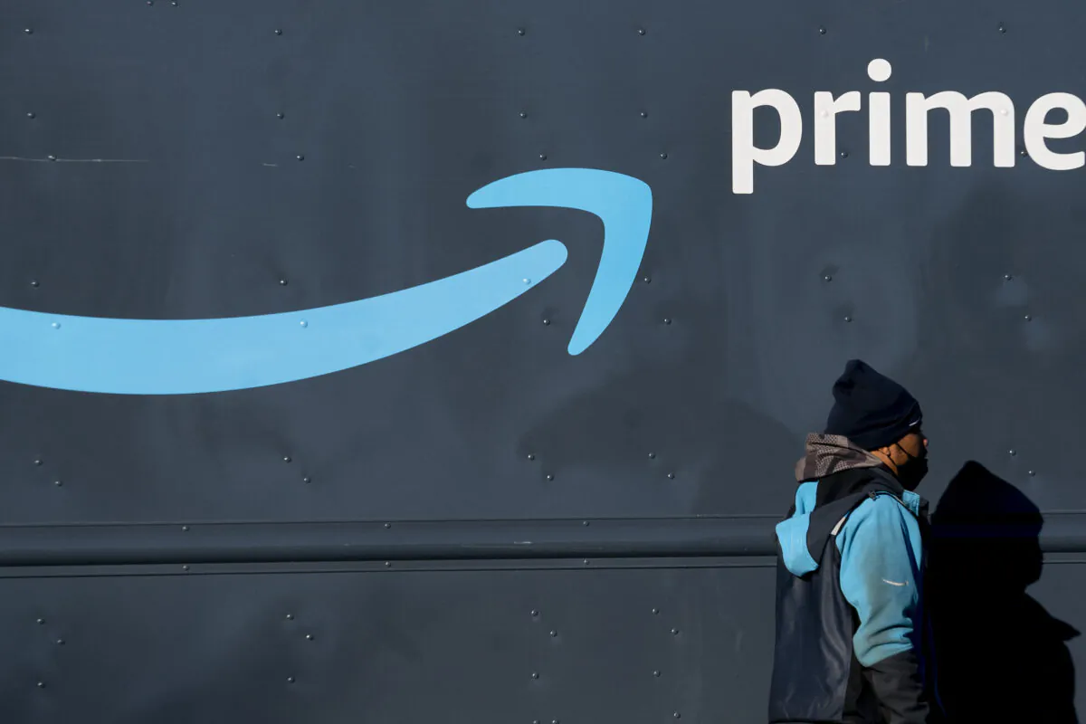 An Amazon worker walks past his Amazon Prime delivery truck in Washington on Feb. 19, 2022. (Stefani Reynolds/AFP via Getty Images)
