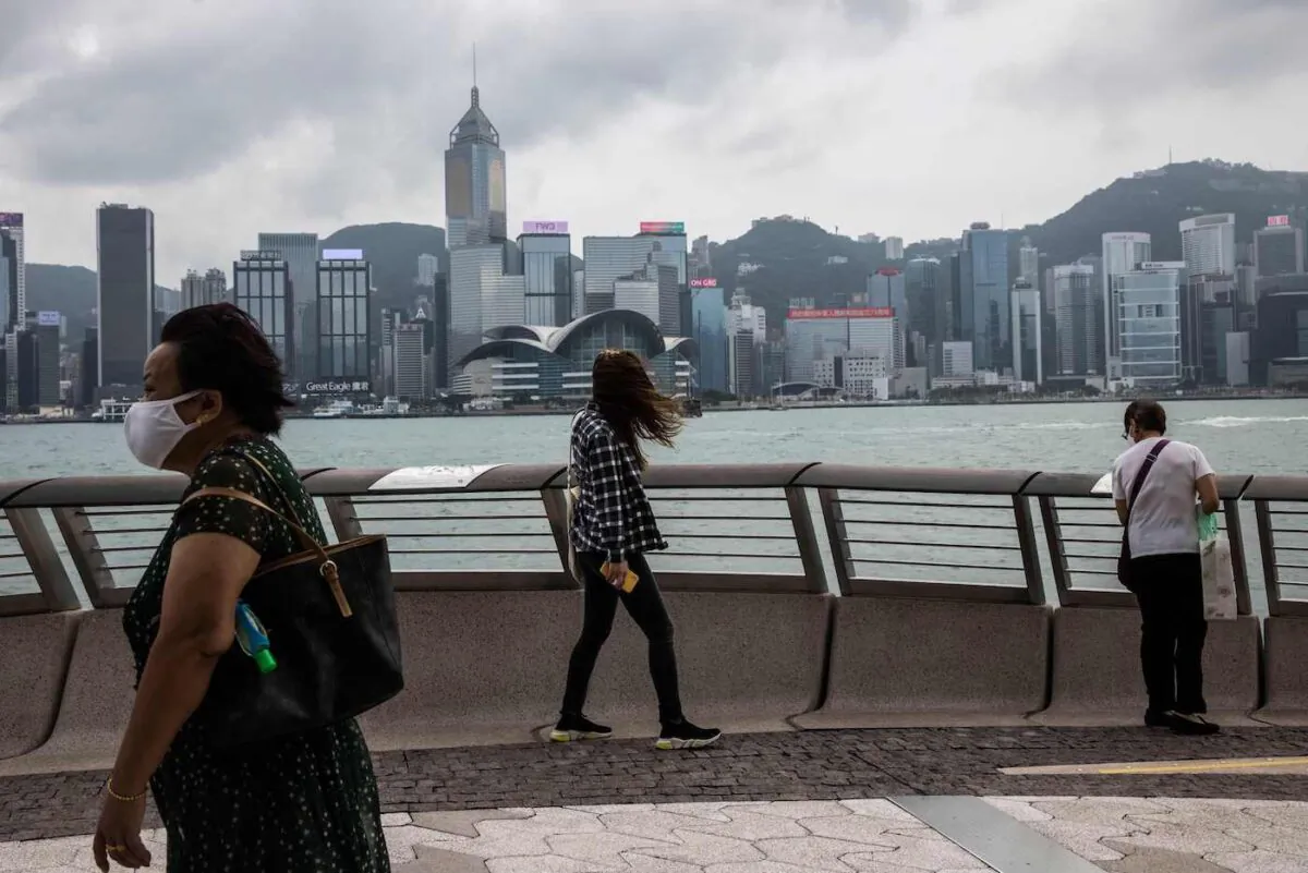 People walk along a promenade by Victoria Harbor in Hong Kong on Sept. 29, 2022. (Isaac Lawrence/AFP via Getty Images)