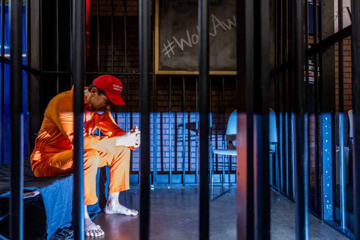 Brandon Straka sits in a simulated jail cell during a demonstration at the Conservative Political Action Conference (CPAC) held at the Hilton Anatole in Dallas, Texas on Aug. 5, 2022. (Brandon Bell/Getty Images)