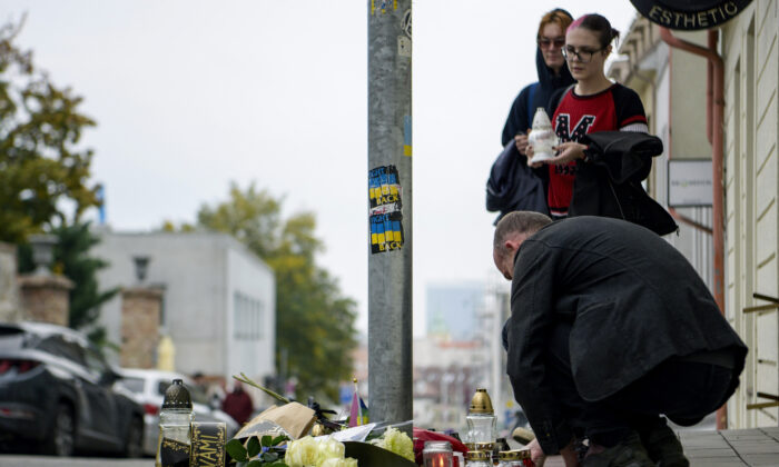 People place flowers and light candles at the site of Wednesday's attack on Zamokka Street in Bratislava, Slovakia, October 13, 2022.  (Pavol Zachar/TASR via AP)