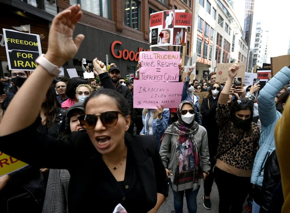 Members of the Iranian community and their supporters rally in solidarity with protesters in Iran, after 22-year-old Mahsa Amini died in police custody for allegedly improperly wearing a hijab, in Ottawa on Sept. 25, 2022. (The Canadian Press/Justin Tang)
