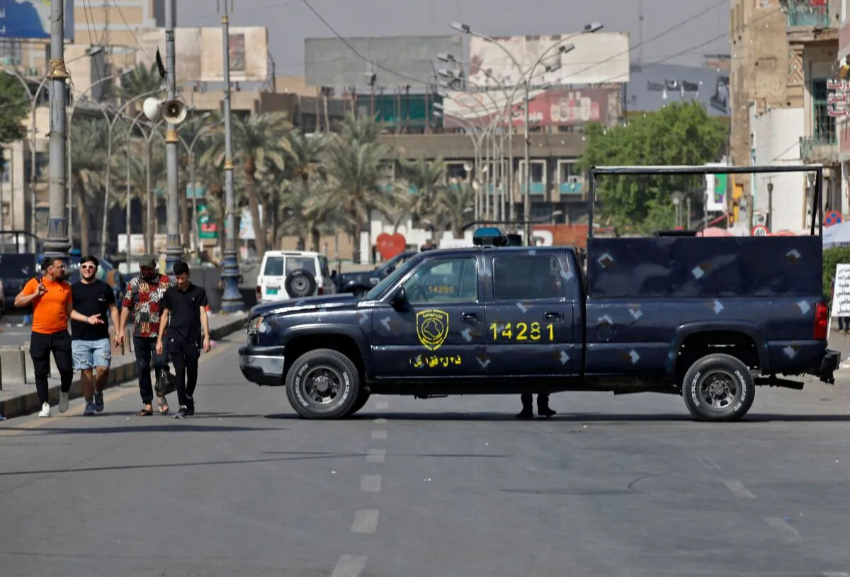 Iraqi security forces block a road leading to the Green Zone in Baghdad as lawmakers gather for their fourth attempt this year to elect a new state president, Iraq, on Oct. 13, 2022. (Ahmad Al-Rubaye/AFP via Getty Images)