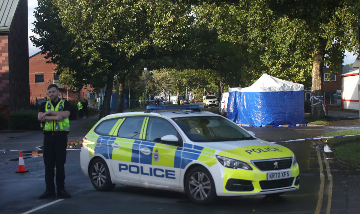 A police officer guards a cordon close to where Marius Ciolac was shot dead by police in the grounds of Ascot Drive police station in Derby on Oct. 7, 2022. (PA)