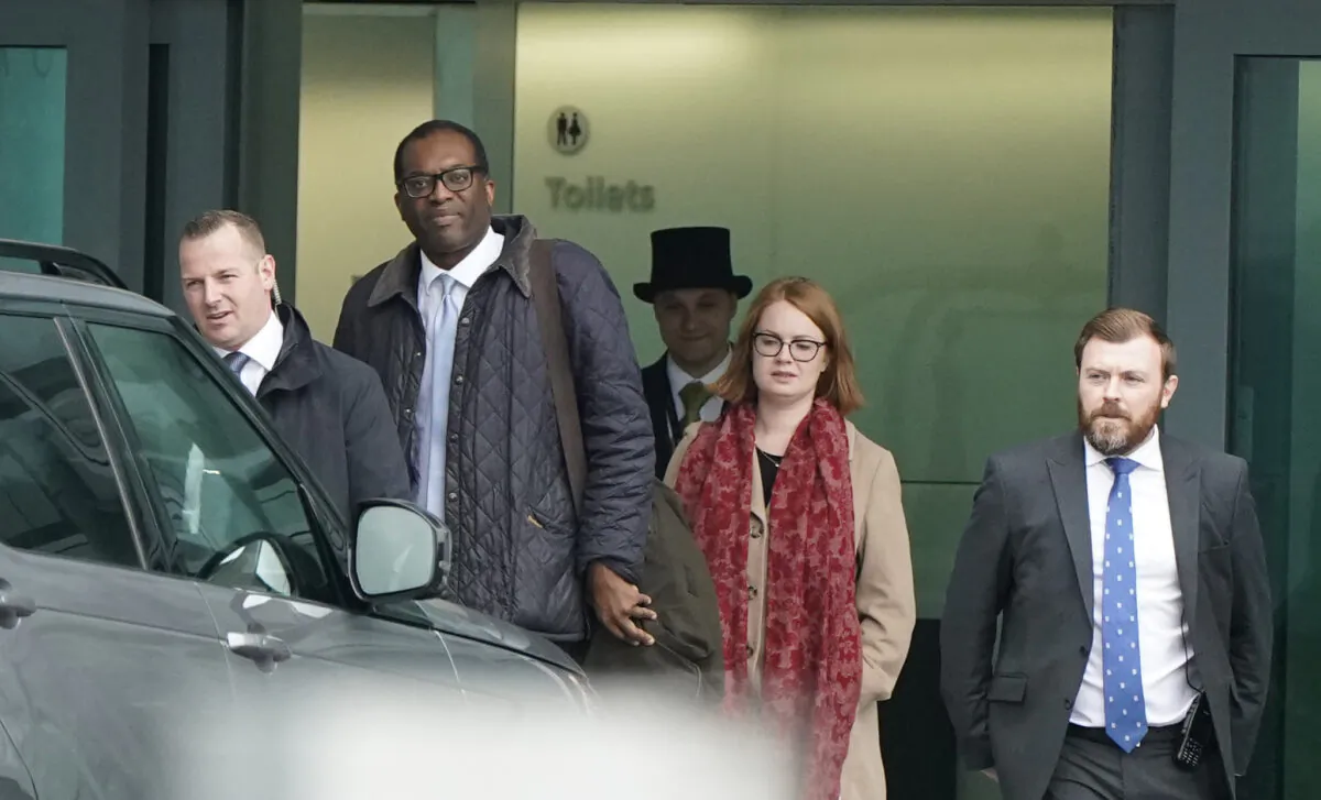 Chancellor of the Exchequer Kwasi Kwarteng (second left) arrives, from the United States, at London's Heathrow Airport on Oct. 14, 2022. (PA)