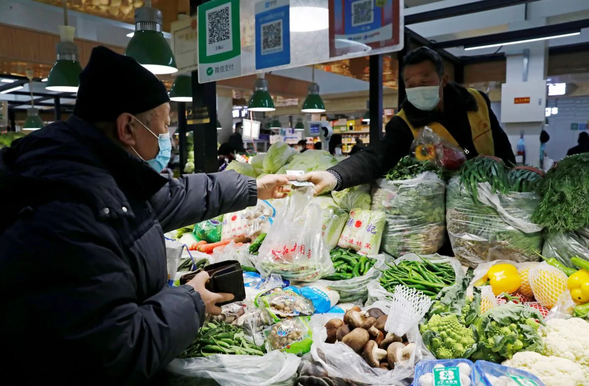 People shop at a market in Beijing on Jan. 11, 2021. (Tingshu Wang/Reuters)