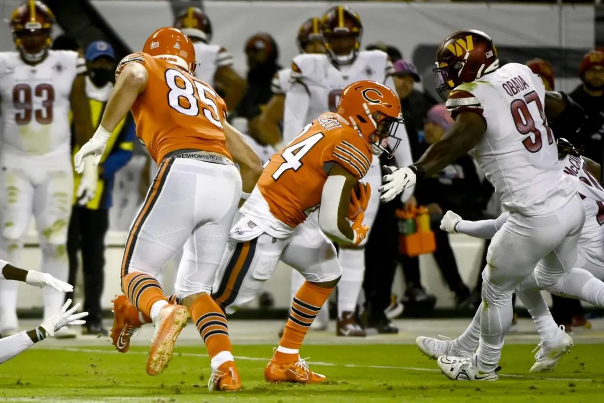 Chicago Bears running back Khalil Herbert (24) runs past Washington Commanders defensive end Efe Obada (97) during the first half at Soldier Field in Chicago on Oct. 13, 2022. (Matt Marton/USA TODAY Sports via Field Level Media)