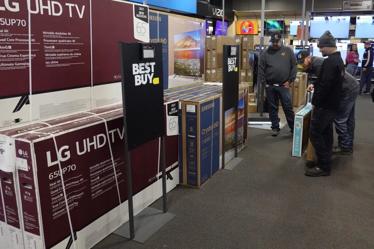 Customers debate on a television selection at Best Buy in Indianapolis on Nov. 26, 2021. (Darron Cummings/AP Photo)