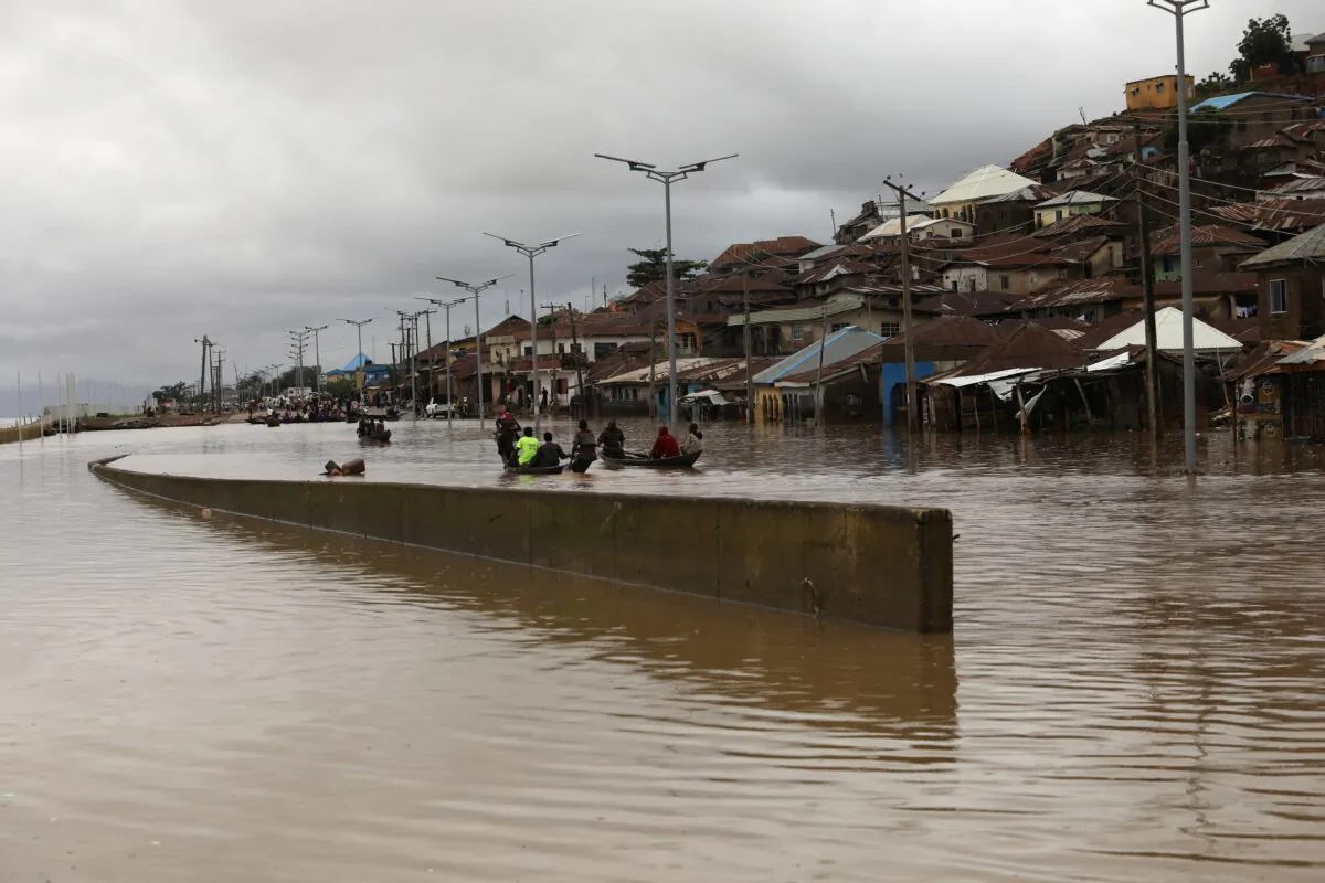 Flood water breaks a river bank and overflows into a settlement in Lokoja, Nigeria, on Oct. 13, 2022. (Afolabi Sotunde/Reuters)