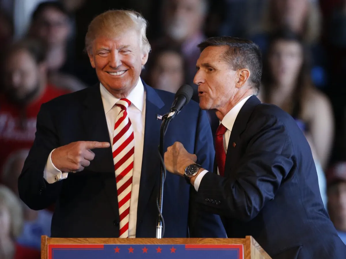 Republican presidential candidate Donald Trump (L) jokes with retired Gen. Michael Flynn as they speak at a rally at Grand Junction Regional Airport in Grand Junction Colorado on Oct. 18, 2016. (TNS)