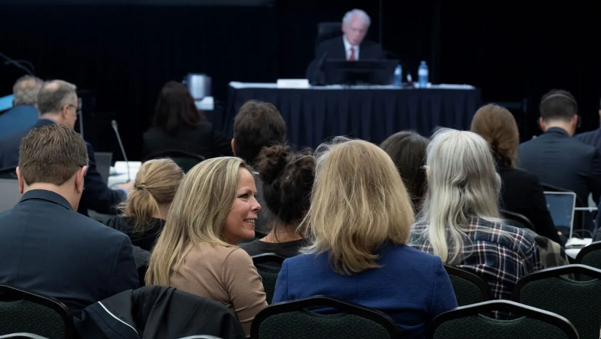 Freedom Convoy organizer Tamara Lich (L) speaks with a lawyer as Public Order Emergency Commission’s Commissioner Paul Rouleau delivers his opening remarks in Ottawa on Oct. 13, 2022. (The Canadian Press/Adrian Wyld)