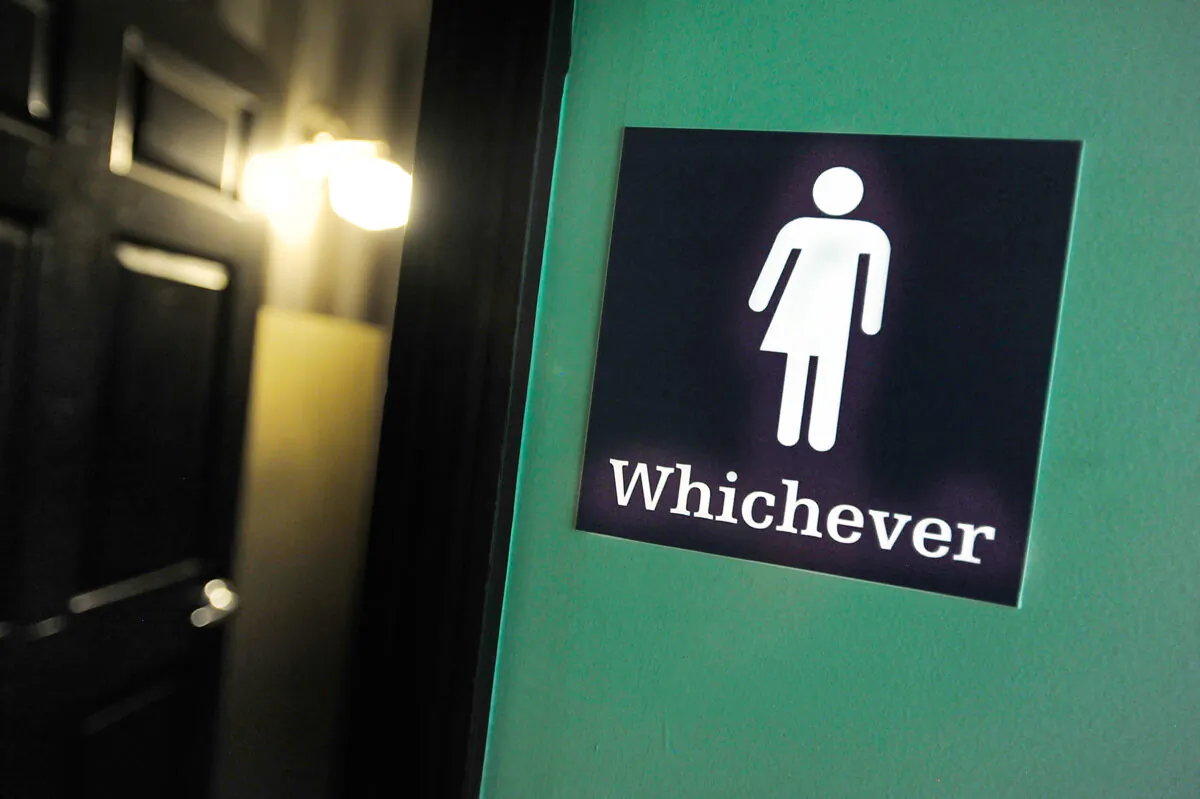 A gender neutral sign is posted outside a bathroom at Oval Park Grill in Durham, N.C., on May 11, 2016. (Sara D. Davis/Getty Images)