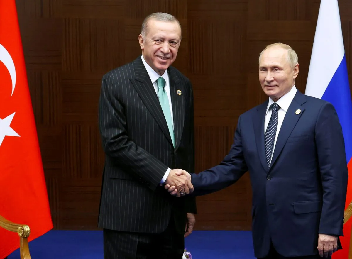 Russia's President Vladimir Putin (R) and Turkey's President Recep Tayyip Erdogan shake hands during their meeting on sidelines of the Conference on Interaction and Confidence Building Measures in Asia (CICA) summit, in Astana, Kazakhstan, on Oct. 13, 2022. (Vyacheslav Prokofyev/Sputnik via AP)