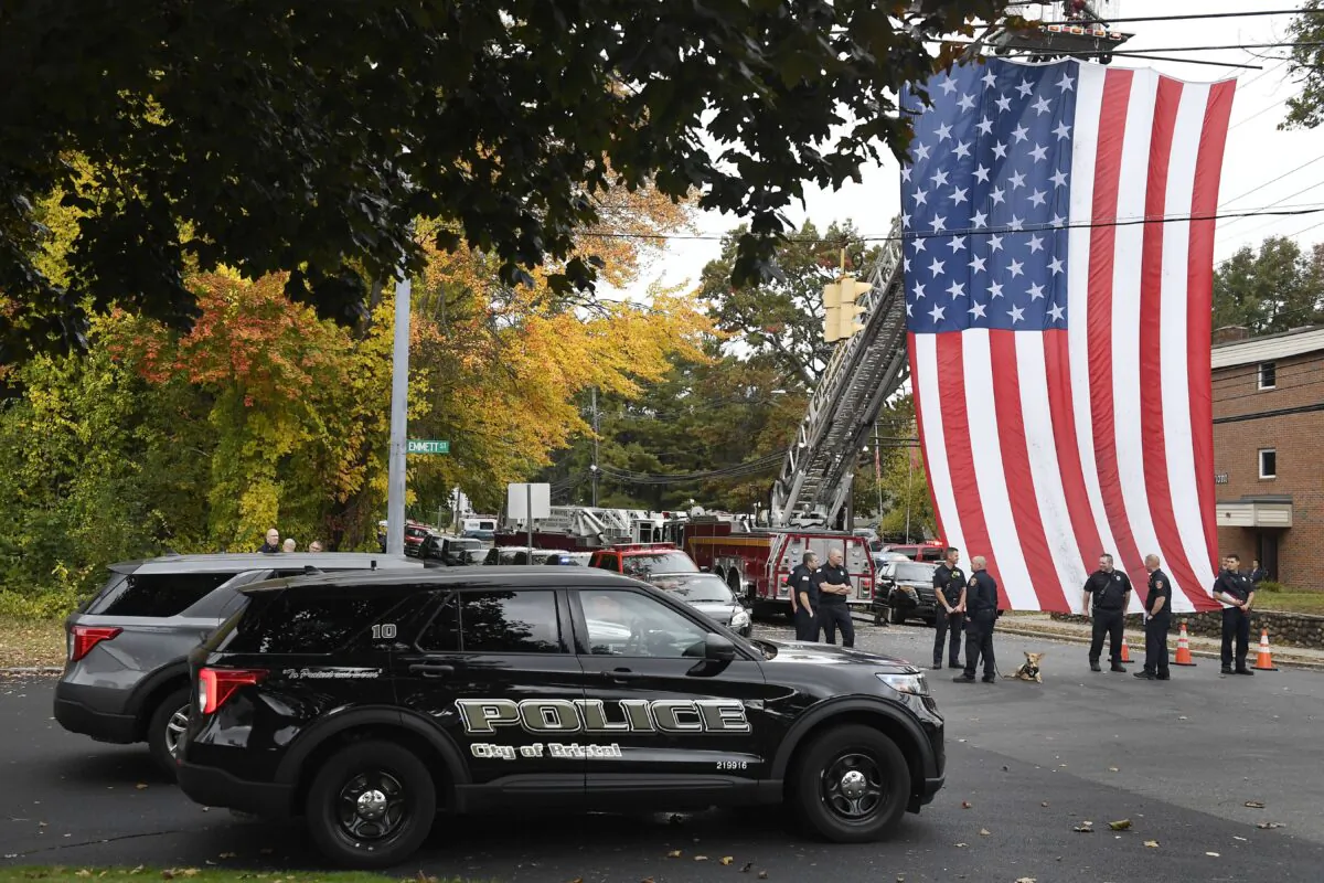 Police officers from Bristol gather with other towns at the scene where two police officers killed, in Bristol, Conn., on Oct. 13, 2022. (Jessica Hill/AP Photo)