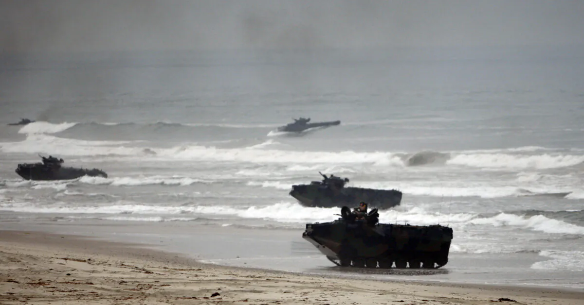 Amphibious Assault Vehicles storm Red Beach during exercises at Camp Pendleton, Calif., on June 2, 2010. (Lenny Ignelzi/AP Photo)