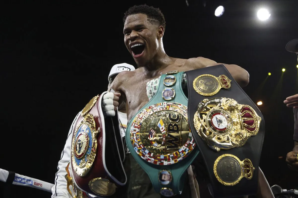 Devin Haney of the United States displays his belts after defeating George Kambosos Jr. of Australia as Haney defends his undisputed lightweight boxing title in Melbourne, Australia, on Oct. 16, 2022. (Hamish Blair/AP Photo)