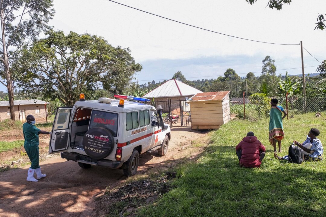 A medical officer from the Uganda Red Cross Society instructs people with suspected Ebola symptoms to enter an ambulance in Madudu near Mubende in Uganda on Sept. 29, 2022. (Hajarah Nalwadda/AP Photo)
