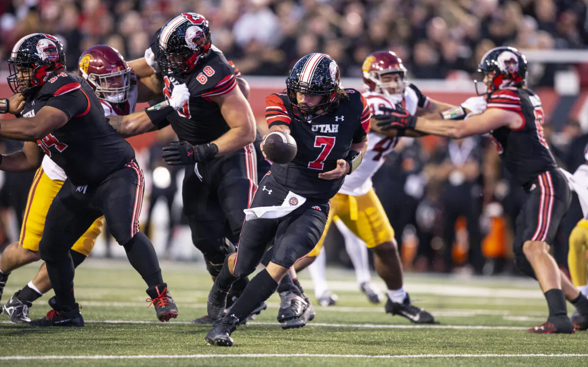 Cameron Rising (7) of the Utah Utes looks to hand off the ball against the USC Trojans during the first half of their game at Rice-Eccles Stadium in Salt Lake City, on Oct. 15, 2022. (Chris Gardner/ Getty Images)