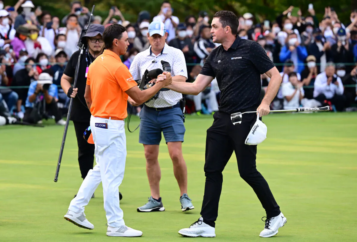 Keegan Bradley (R) of the United States shakes hands with Rickie Fowler (L) after winning the tournament on the 18th green during the final round of the ZOZO Championship at Accordia Golf Narashino Country Club  in Inzai, Chiba, Japan, on Oct. 16, 2022. (Atsushi Tomura/Getty Images)
