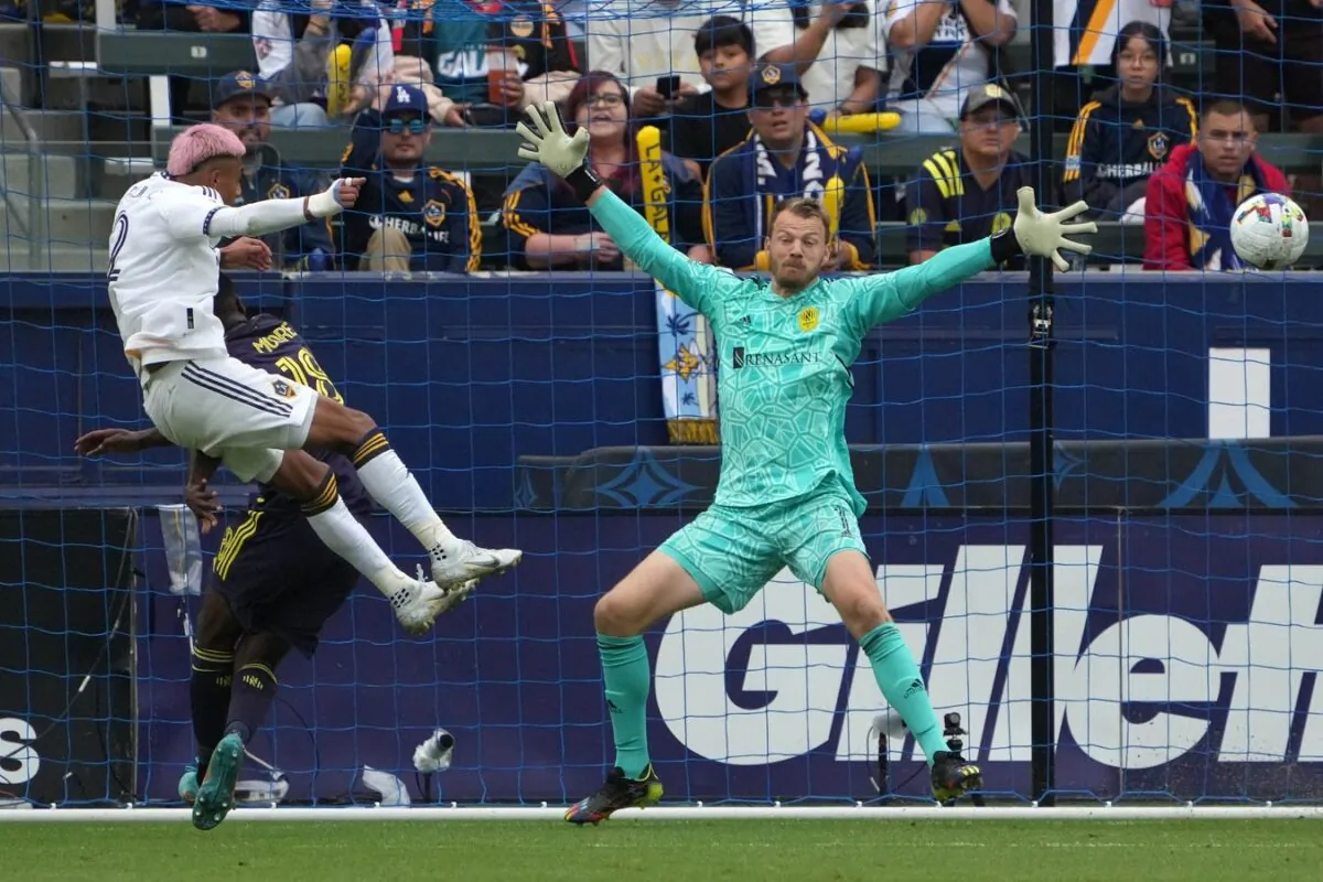 Los Angeles Galaxy defender Julian Araujo (2) scores a goal during the second half against Nashville SC goalkeeper Joe Willis (1) at Dignity Health Sports Park, in Carson, Calif., on Oct 15, 2022. (Kirby Lee-USA TODAY Sports)