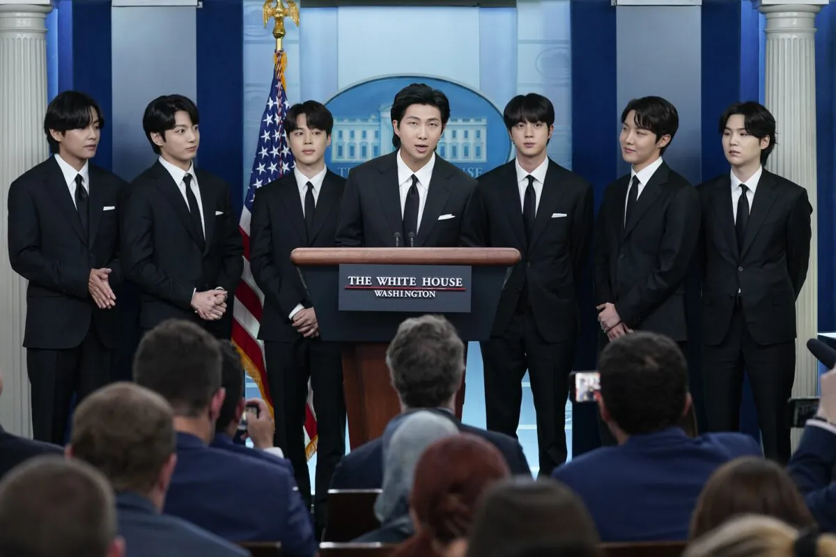 RM (C) accompanied by other K-pop group BTS members (L–R) V, Jungkook, Jimin, Jin, J-Hope, and Suga speaks during the daily briefing at the White House on May 31, 2022. (Evan Vucci/AP Photo)