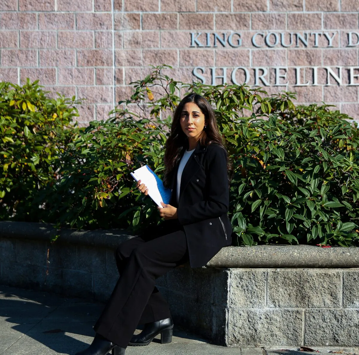 Licensed esthetician Simran Bal, who was taken to court by her former employer to repay $1,900 in trainings they required her to attend, poses for a portrait outside the King County District Court in Shoreline, Wash., on Oct. 13, 2022. Bal, whose case was dismissed, says she was already licensed for services the trainings covered. (Reuters/Lindsey Wasson)
