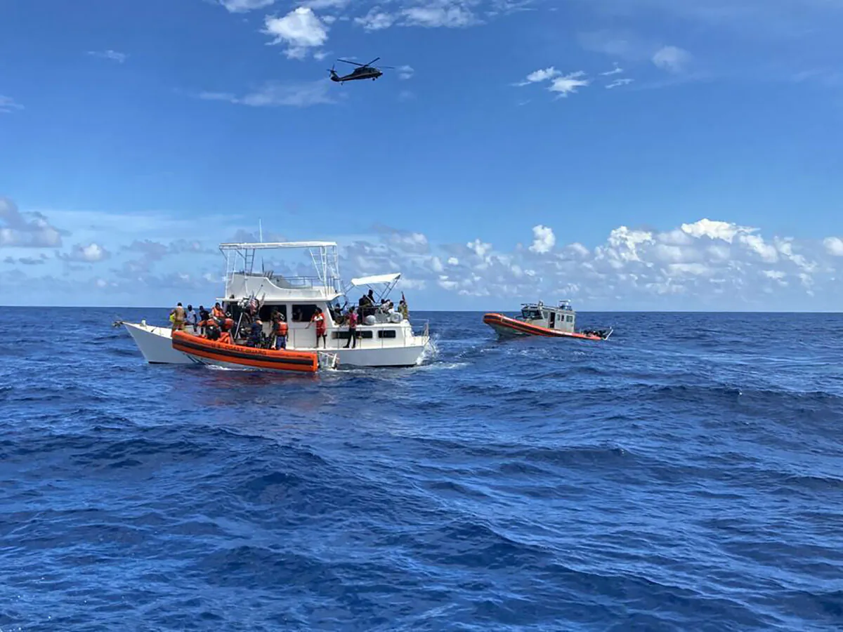 Coast Guard law enforcement crews aid people from an unsafe and overloaded 40-foot cabin cruiser about 20 miles off Boca Raton, Fla., on Oct. 12, 2022. (U.S. Coast Guard via AP)