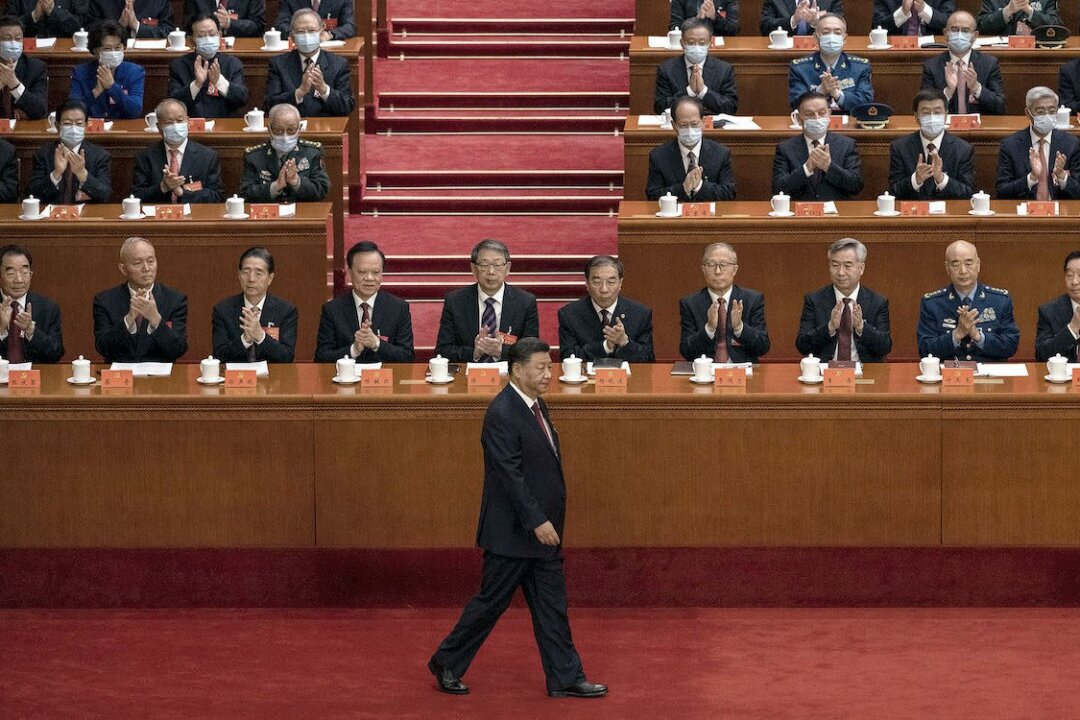 Chinese leader Xi Jinping (C) is applauded by senior members of the Communist Party and delegates as he walks to the podium to make a speech during the opening ceremony of the 20th National Congress in Beijing, China, on Oct. 16, 2022. (Kevin Frayer/Getty Images)