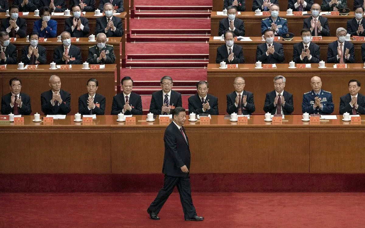 Chinese leader Xi Jinping (C) is applauded by senior members of the Communist Party and delegates as he walks to the podium to make a speech during the opening ceremony of the 20th National Congress in Beijing, China, on Oct. 16, 2022. (Kevin Frayer/Getty Images)