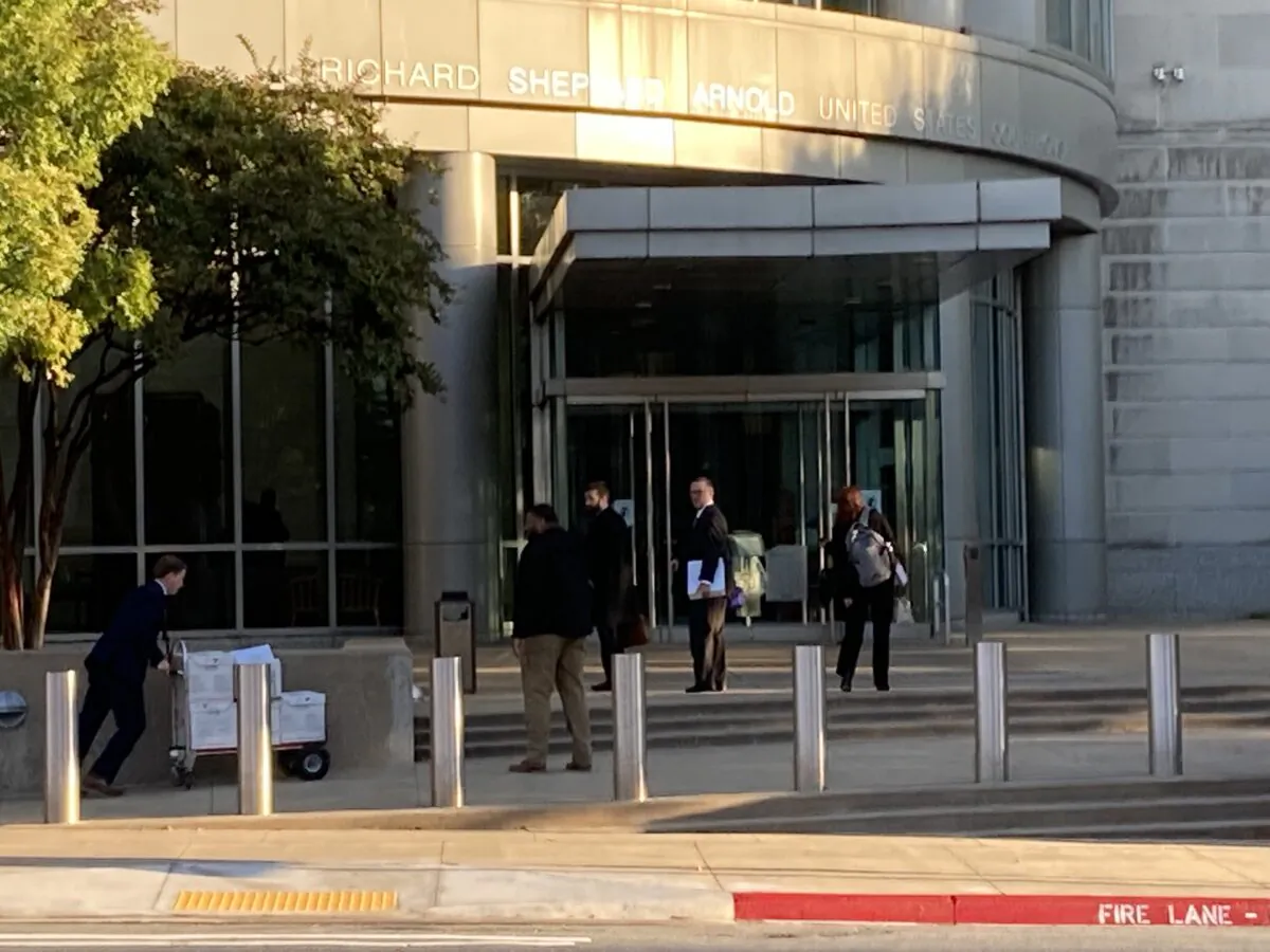 Attorneys push a cart laden with files in the complex case of Brandt v. Rutledge, which challenges the constitutionality of an Arkansas law banning transgender medical treatments for minors, as a trial begins on Oct. 17, 2022. (Janice Hisle/The Epoch Times)