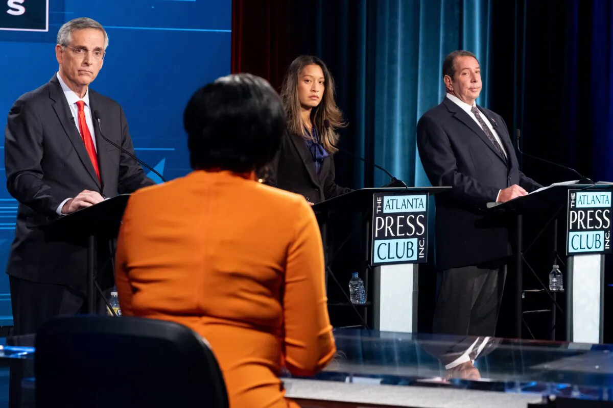 At Georgia's Secretary of State debate, from left to right facing the camera, incumbent Republican Brad Raffensperger, Democrat Bee Nguyen and Libertarian Ted Metz.  With her back to the camera is moderator Lisa Rayam of WABE. (Photo REUTERS/Dustin Chambers/Pool.)