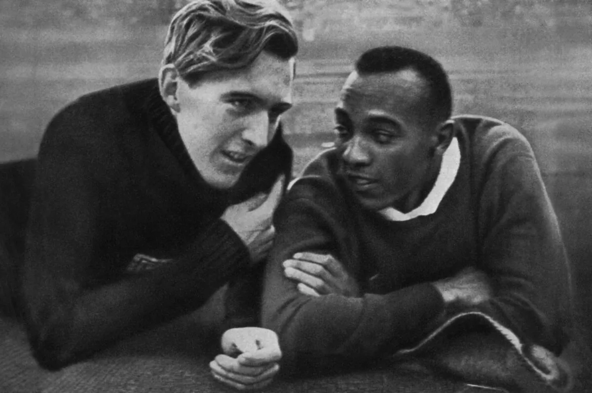 U.S. champion Jesse Owens (R) and German champion Luz Long (L) chat together on the Berlin stadium during the Olympic Games in Berlin on Aug. 1, 1936. (Corr/Ho/AFP via Getty Images)