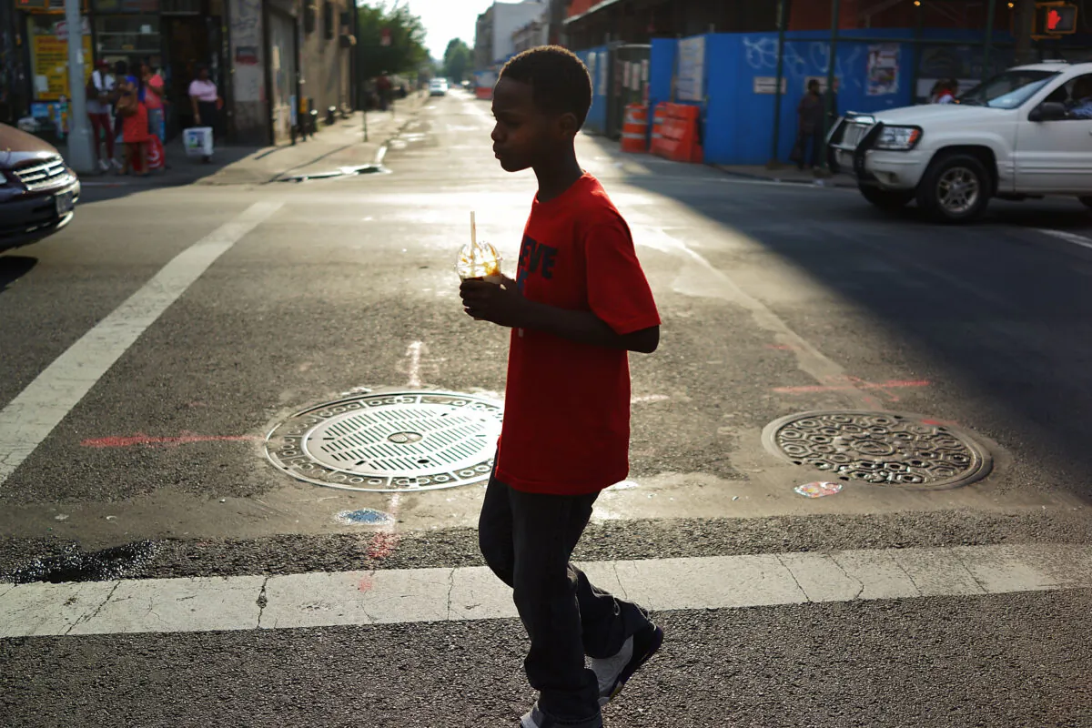 A boy walks down a street in the Brooklyn borough of New York on July 23, 2013. (Spencer Platt/Getty Images)