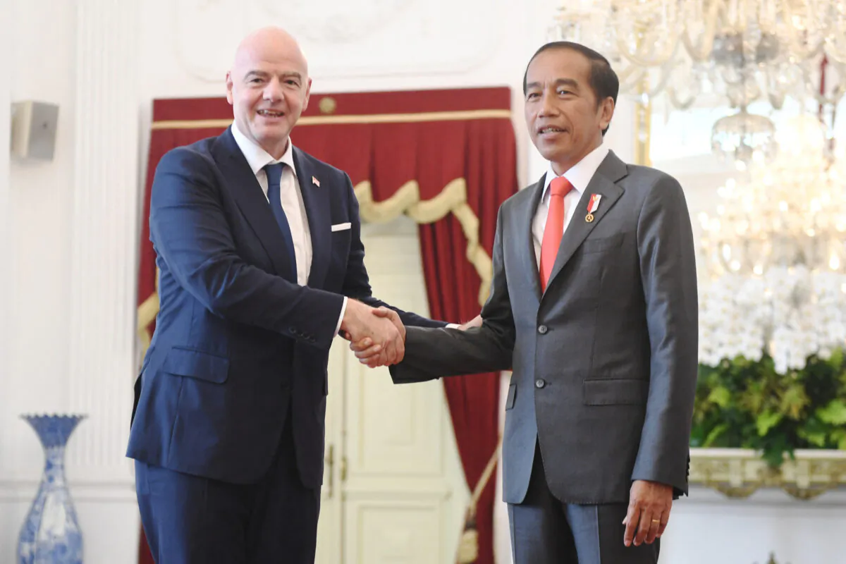 Indonesian President Joko Widodo shakes hands with FIFA’s president Gianni Infantino during their meeting at the Merdeka Palace in Jakarta, Indonesia, on Oct.18, 2022. (Antara Foto/Hafidz Mubarak A/via Reuters)