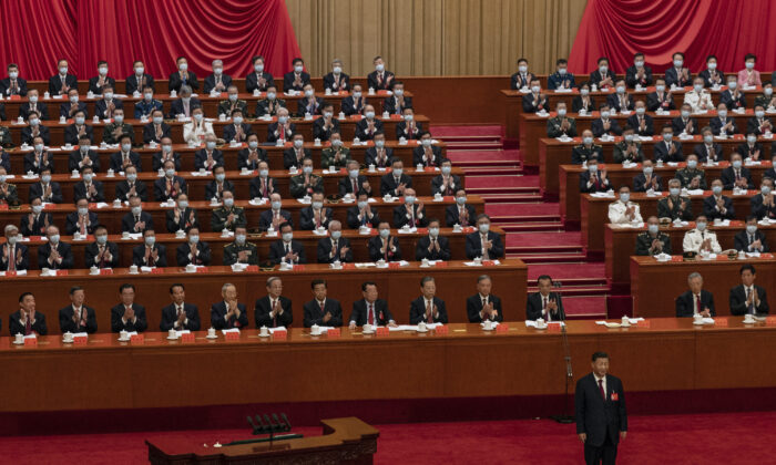 2022 年 10 月 16 日,中国领导人习近平(右下)在北京人民大会堂举行的党的二十大开幕式上发表讲话,受到中国共产党高级成员的鼓掌。(凯文弗雷尔/盖蒂图片社)