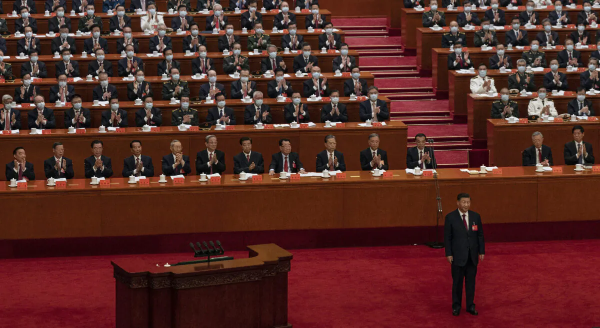 Chinese President Xi Jinping, bottom right, is applauded by senior members of the government and delegates as he stands before his speech during the Opening Ceremony of the 20th National Congress of the Communist Party of China at The Great Hall of People on October 16, 2022 in Beijing, China. (Photo by Kevin Frayer/Getty Images)