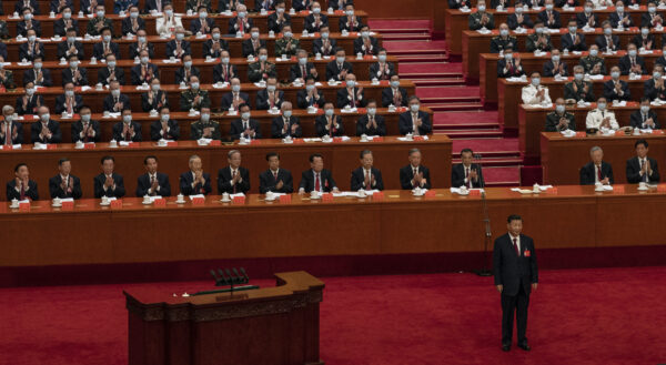 BEIJING, CHINA - OCTOBER 16: Chinese President Xi Jinping, bottom right, is applauded by senior members of the government and delegates as he stands before his speech during the Opening Ceremony of the 20th National Congress of the Communist Party of China at The Great Hall of People on October 16, 2022 in Beijing, China. Xi Jinping is widely expected to secure a third term in power. (Photo by Kevin Frayer/Getty Images)