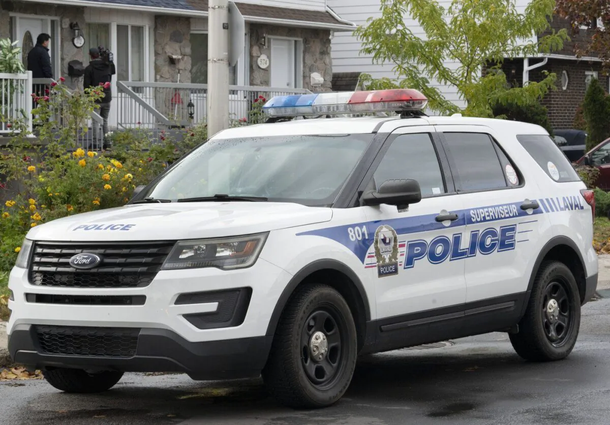 A police vehicle is shown outside a house in Laval, Que.,Oct. 18, 2022. (The Canadian Press/Ryan Remiorz)