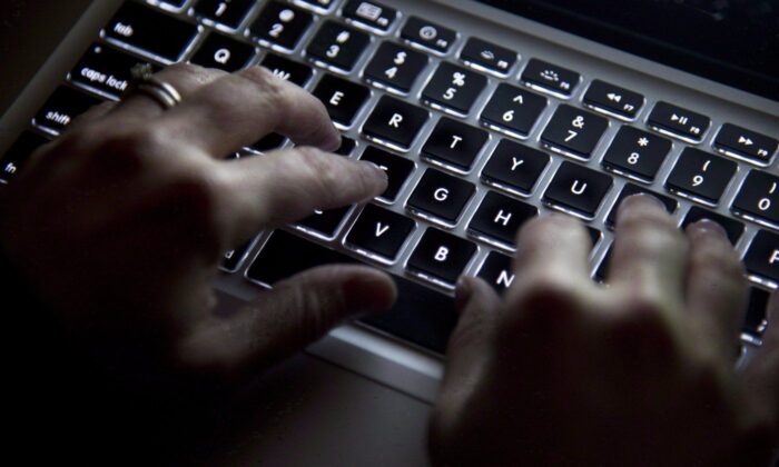 Hands type on a keyboard in North Vancouver, B.C., on December, 19, 2012. (The Canadian Press/Jonathan Hayward)
